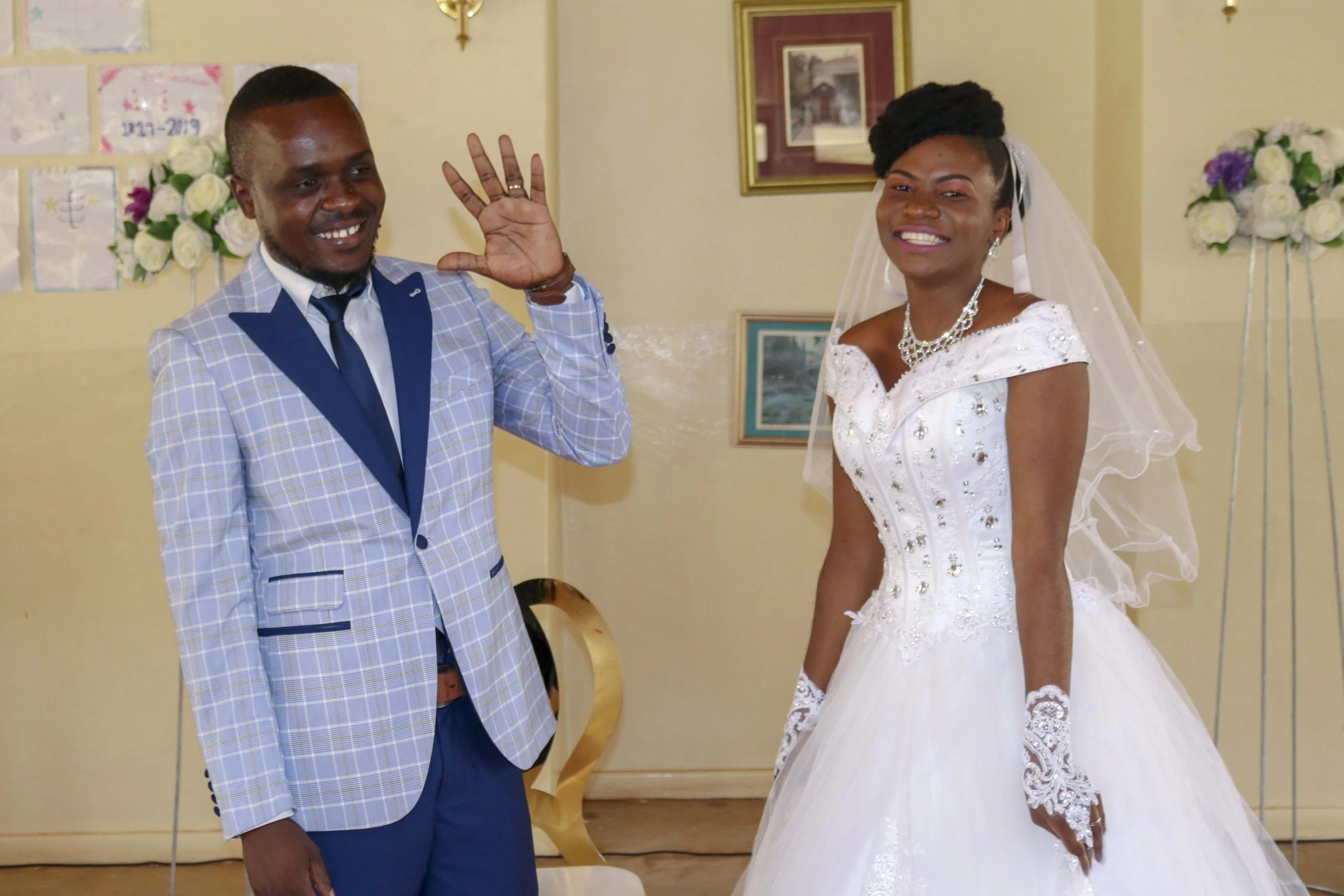 Newly wedded couple waving